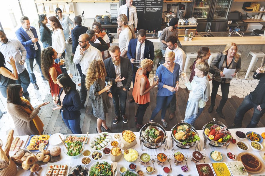A workplace crowded near a foodstand for a funfull event