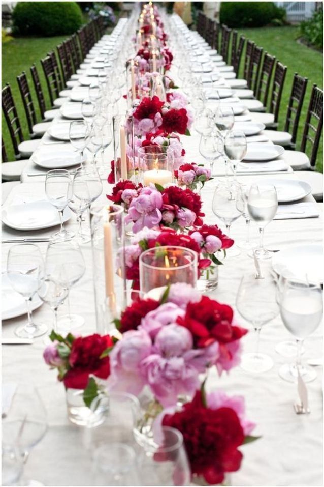 A long table set with a white tablecloth