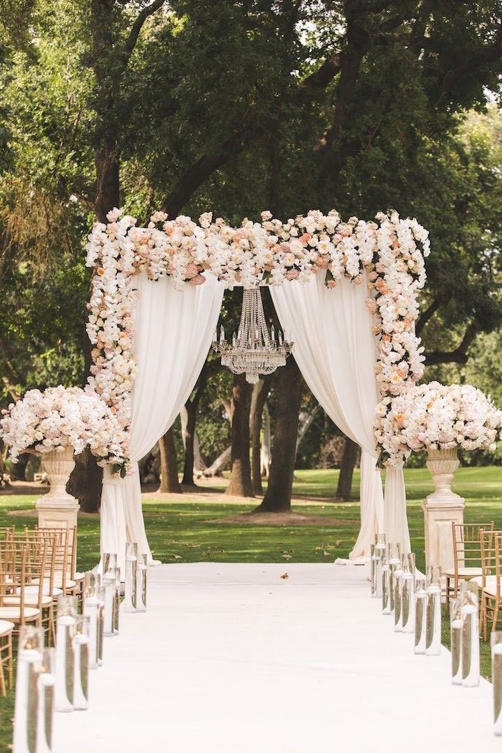 A weeding alley with many flowers and a white carpet