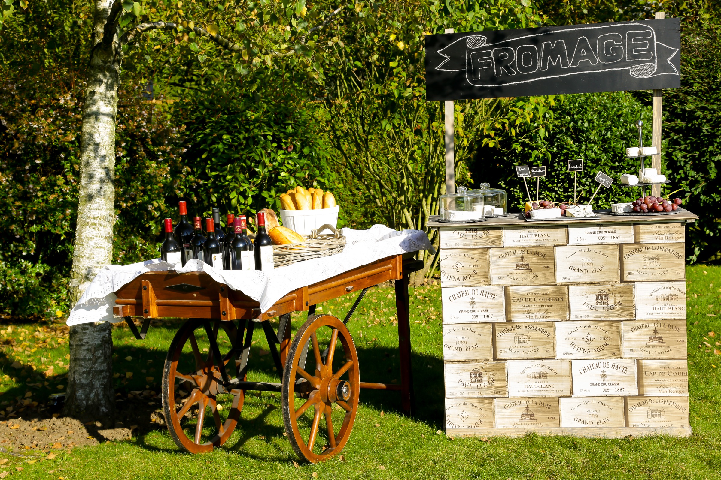 A cart pulling bottles of wine next to a bar